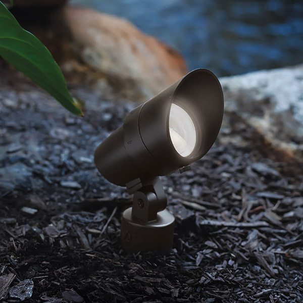 Outdoor Bollard & Spike Spotlights: Exterior LED adjustable spike spotlight in a garden at night, switched on