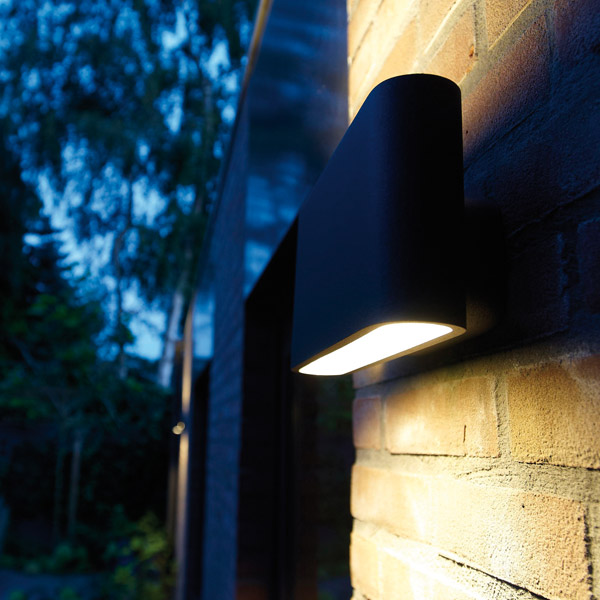 Outdoor Wall Lights: Exterior contemporary wall light shining up & down a brick wall at night 