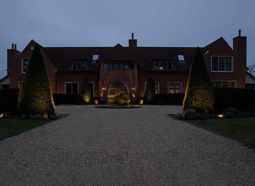 Project Portfolio: exterior of huge country home & landscaped grounds at night