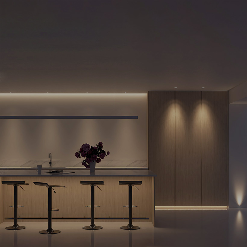 Interactive Lighting Design: contemporary kitchen, ceiling linear lighting, downlights, breakfast bar light & floor uplight on