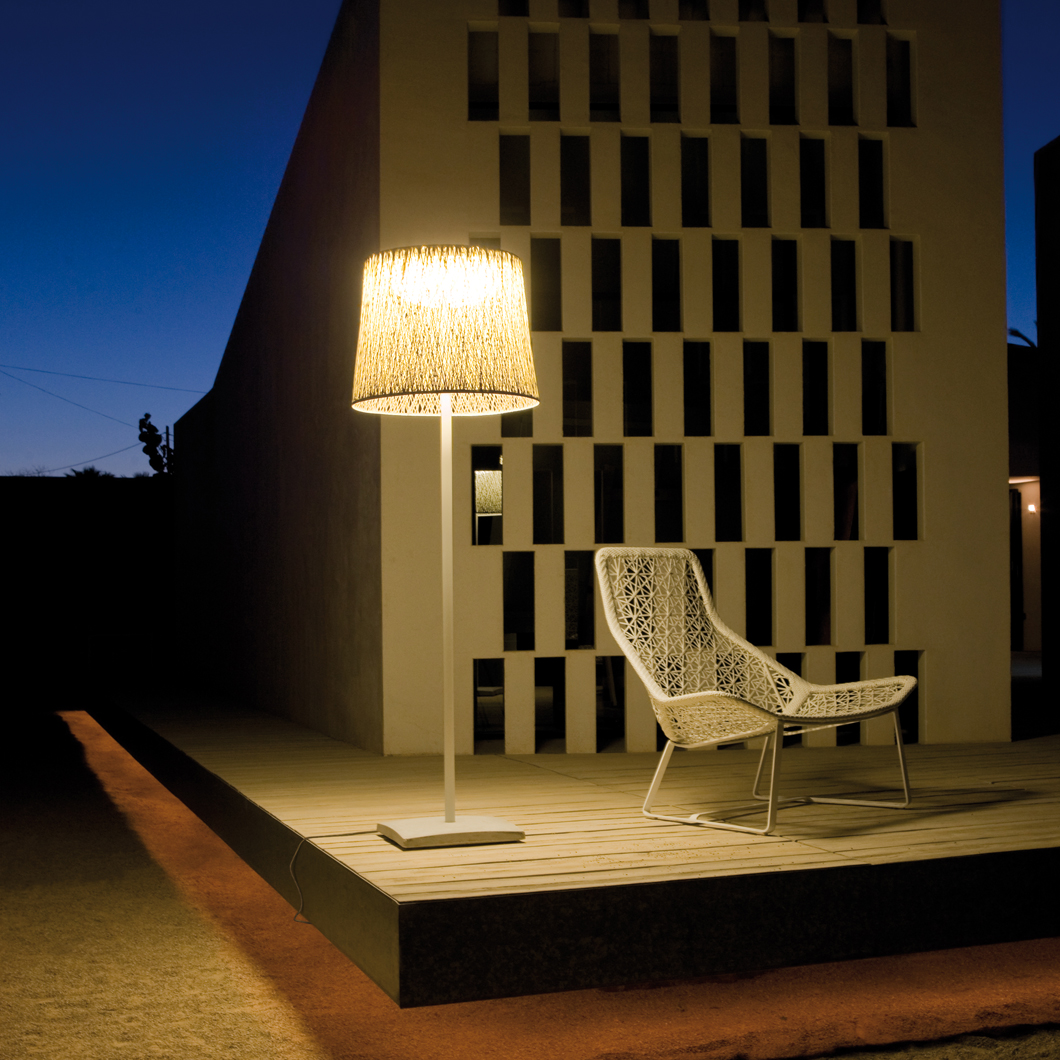 Vibia Wind Slim outdoor floor lamp lighting a chair in an ultra modern outdoor space