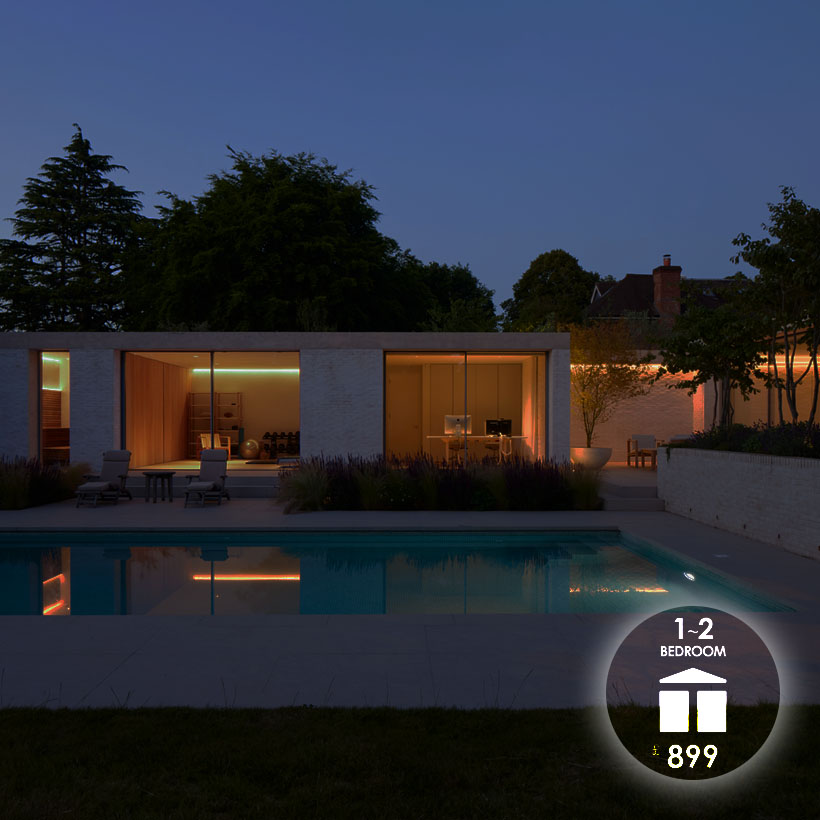 Lighting Design To Go: 1-2 bedroom package £899 exterior shot at night of a 2 room extension and swimming pool