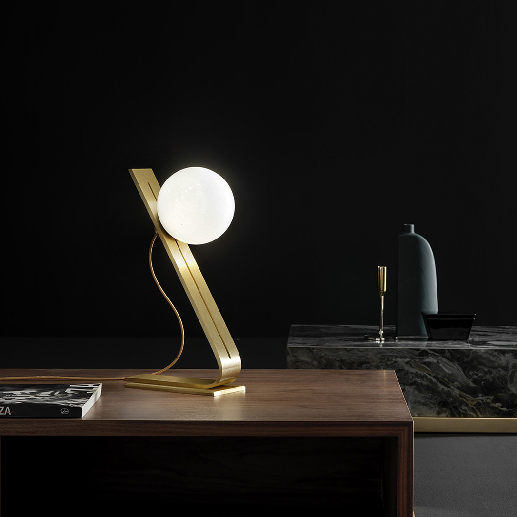 Side on view of Esperia Daphne Table Lamp, highlighting brass structure and milky white sphere lampshade alternative image