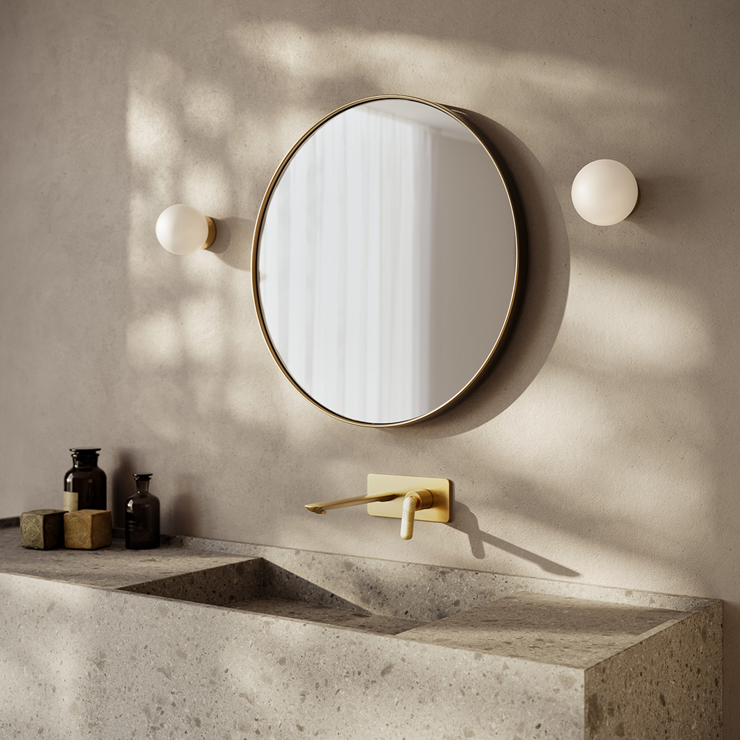 Round wall light with white bulb and brass base shown on white background alternative image