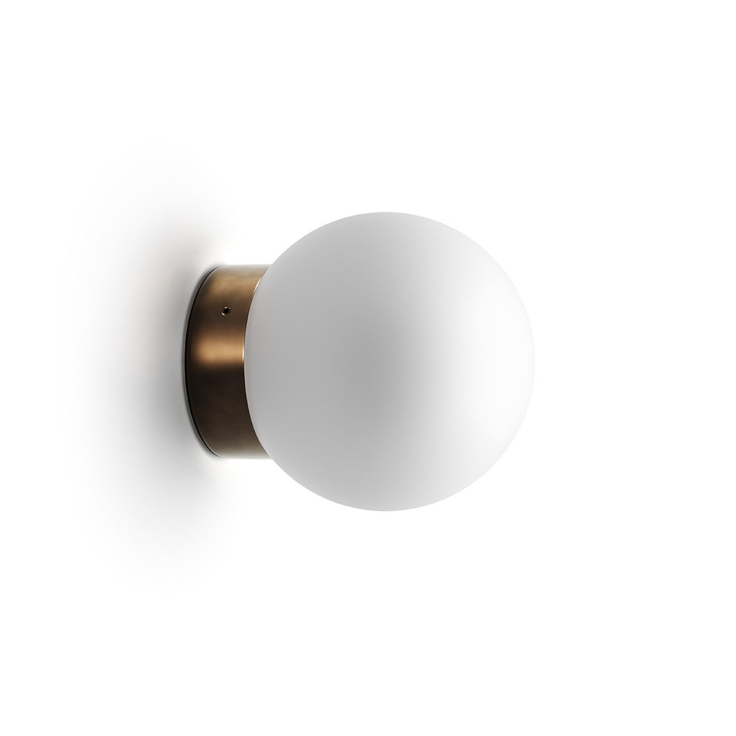 Round wall light with white bulb and brass base shown on white background