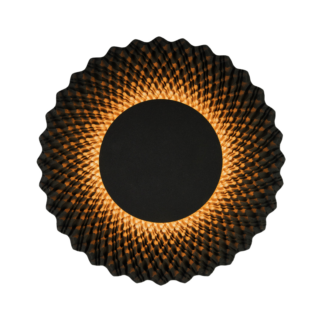 Round sand lamp with warm glow illuminating complex sunflower-like design